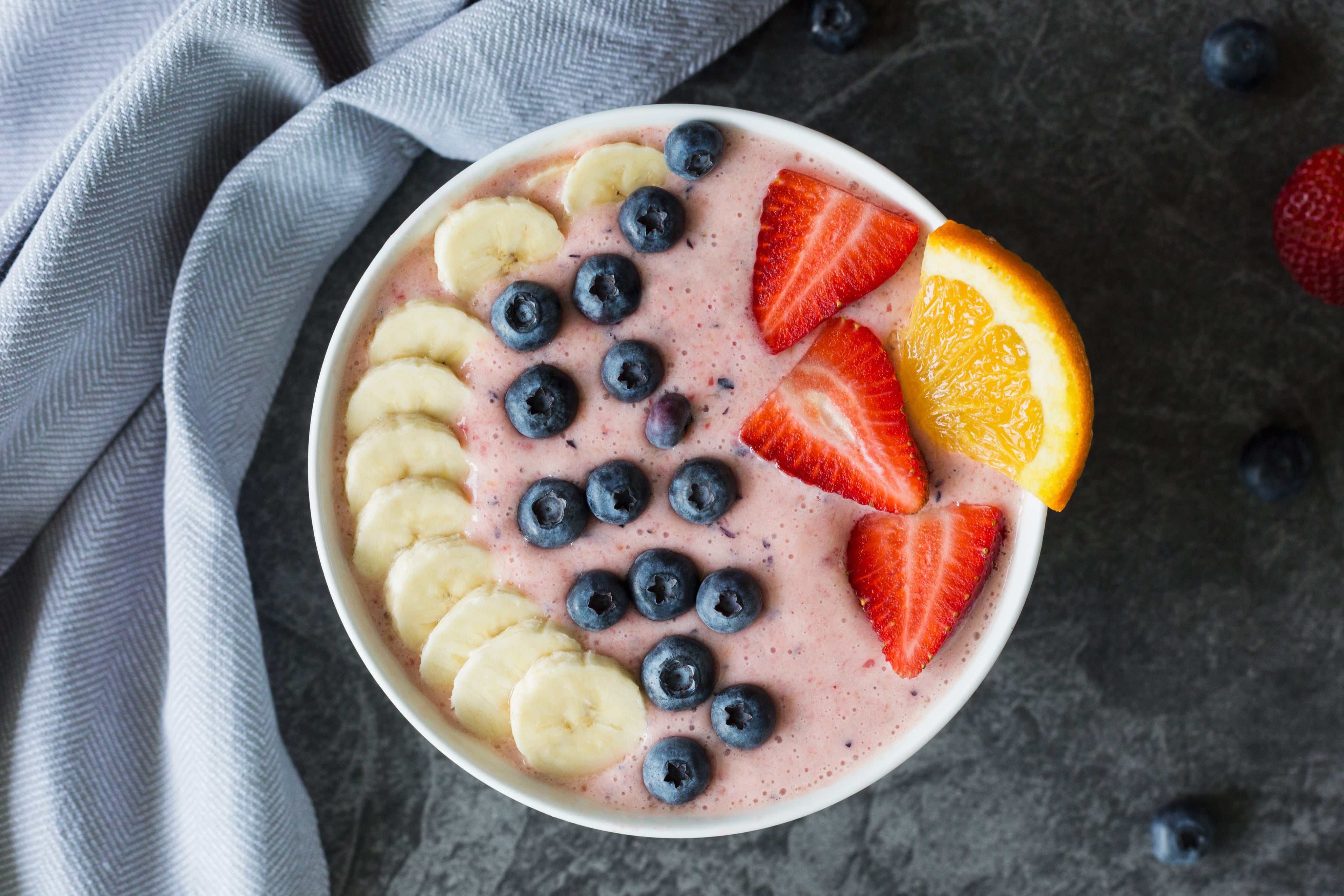 banana and berries in smoothie bowl with whey protect