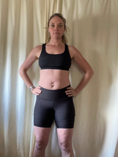 person with baby weight and black sports bra